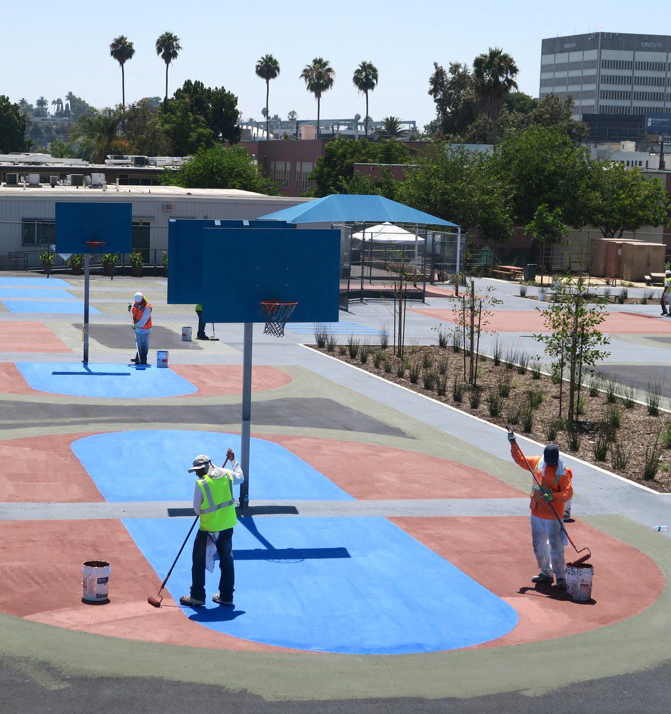 Logan Street basketball courts and playground being painted